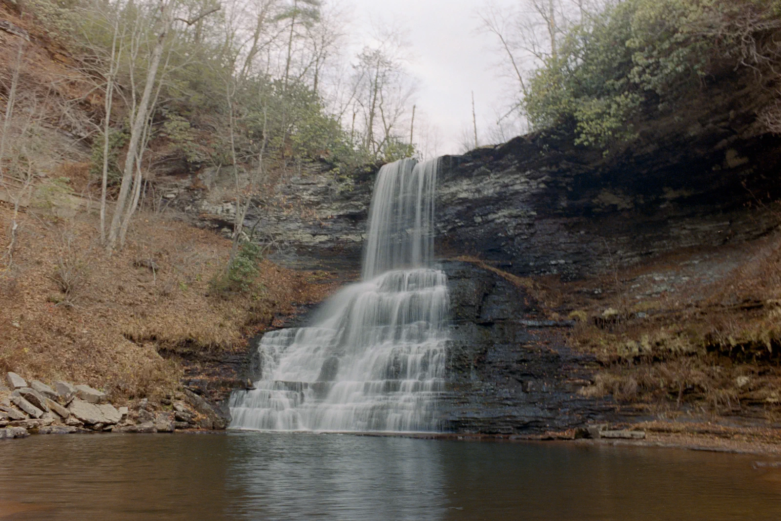 Cascade Falls flowing over layered rock into a pool